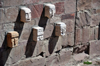 La Paz, Bolivia: carved stone heads of defeated enemies embedded in the wall - replica of the Tiahuanaco Templete Semisubterneo - Tiwanaku Square - photo by M.Torres