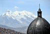 La Paz, Bolivia: dome of the Metropolitan Cathedral, Illimani mountain and shanty towns in between - photo by M.Torres