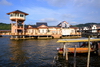 Bandar Seri Begawan, Brunei Darussalam: moored boat and visitors' center tower at Kampung Ayer water village - photo by M.Torres