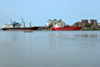 Cameroon, Douala: harbor scene - freighter ships and port installations - silos and warehouses, Cimencam cement grinding station and import terminal - Ports Authority Douala - photo by M.Torres