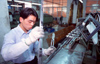 Dongguan, Guangdong province, China: Chinese factory worker with  pliers - photo by B.Henry