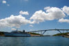 Curacao - Willemstad: Cruise ship moored on St. Annbaai channel, with Queen Julianabridge towering above - photo by S.Green