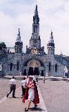 France - Lourdes (Hautes-Pyrnes): Lourdes: Order of Malta volunteer and the Basilica (photo by Miguel Torres)