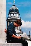 Germany - Berlin: Gendarmenmarket - man reading a newspaper in Midtown of Berlin - French Cathedral / Franzsischer Dom - Huguenot church and museum - photo by W.Schmidt