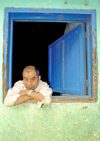 Guatemala - Panajachel - Lago de Atitln - Solol department: man in window - Lake Atitln (photo by A.Walkinshaw)