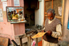 Varanasi, Uttar Pradesh, India: barber waiting for work on the ghats of the Ganges - people in the mirror - photo by G.Koelman