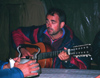 Kazakhstan - Almaty oblys: a guitarist plays and a man warms his hand on a kettle - photo by E.Petitalot