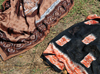 Tsimafana, Belo sur Tsiribihina,  Menabe Region, Toliara Province, Madagascar: pareos drying on the ground - photo by M.Torres