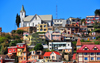 Antananarivo / Tananarive / Tana - Analamanga region, Madagascar: church perched on a hill - houses on the slope - Haute-Ville - photo by M.Torres