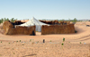 Nouakchott province, Mauritania: traditional Moor tent surrounded by protective thatched wall - white khaima tent in the sand dunes of the Sahara desert - photo by M.Torres