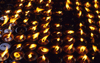 Kathmandu, Nepal: butter lamps at a stupa - an allegory compares Buddhist reincarnation with the flame of a candle, as time passes neither the candle itself, nor the flame, are the same, but without the first candle there would be no flame - photo by W.Allgwer