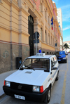 Sassari / Tthari, Sassari province, Sardinia / Sardegna / Sardigna: Via Brigata Sassari - Fiat Panda of the Municipal Police in front of the Central Post Office - Palazzo delle Poste e Telegrafi - designed by the engineer Bruno Cipelli - photo by M.Torres