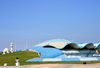 Dammam, Eastern Province, Saudi Arabia: shell roundabout with its clam shaped fountain, Corniche Mosque in the background - photo by M.Torres