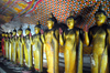 Dambulla, Central Province, Sri Lanka: line of Buddhas greeting the visitor - Maha Alut Vihara cave - Dambulla cave temple - UNESCO World Heritage Site - photo by M.Torres