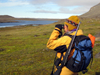 Svalbard - Spitsbergen island: armed with a rifle, expedition leader, Sue Werner, keeps a lookout for polar bears as passengers trek across the tundra. Strict procedures are in place for both guides and tourists to protect themselves and the endangered bears - photo by R.Eime