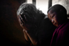 Tibet - pilgrims worshipping - woman and boy - photo by Y.Xu