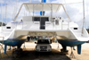 Port of Spain, Trinidad: catamaran undergoing repairs used like a garage at the harbour - Northern Light - photo by E.Petitalot