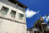 Stone Town, Zanzibar, Tanzania: building and wall on Mizingani Road - windows with shutters - photo by M.Torres